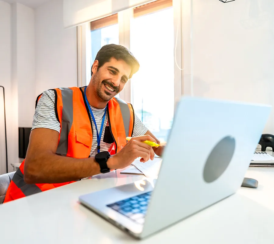 High-vis worker using TipManager software for load tracking and account management.